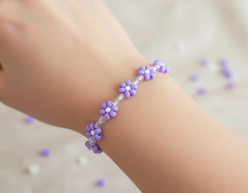 hand wrist wearing a bead daisy bracelet purple an