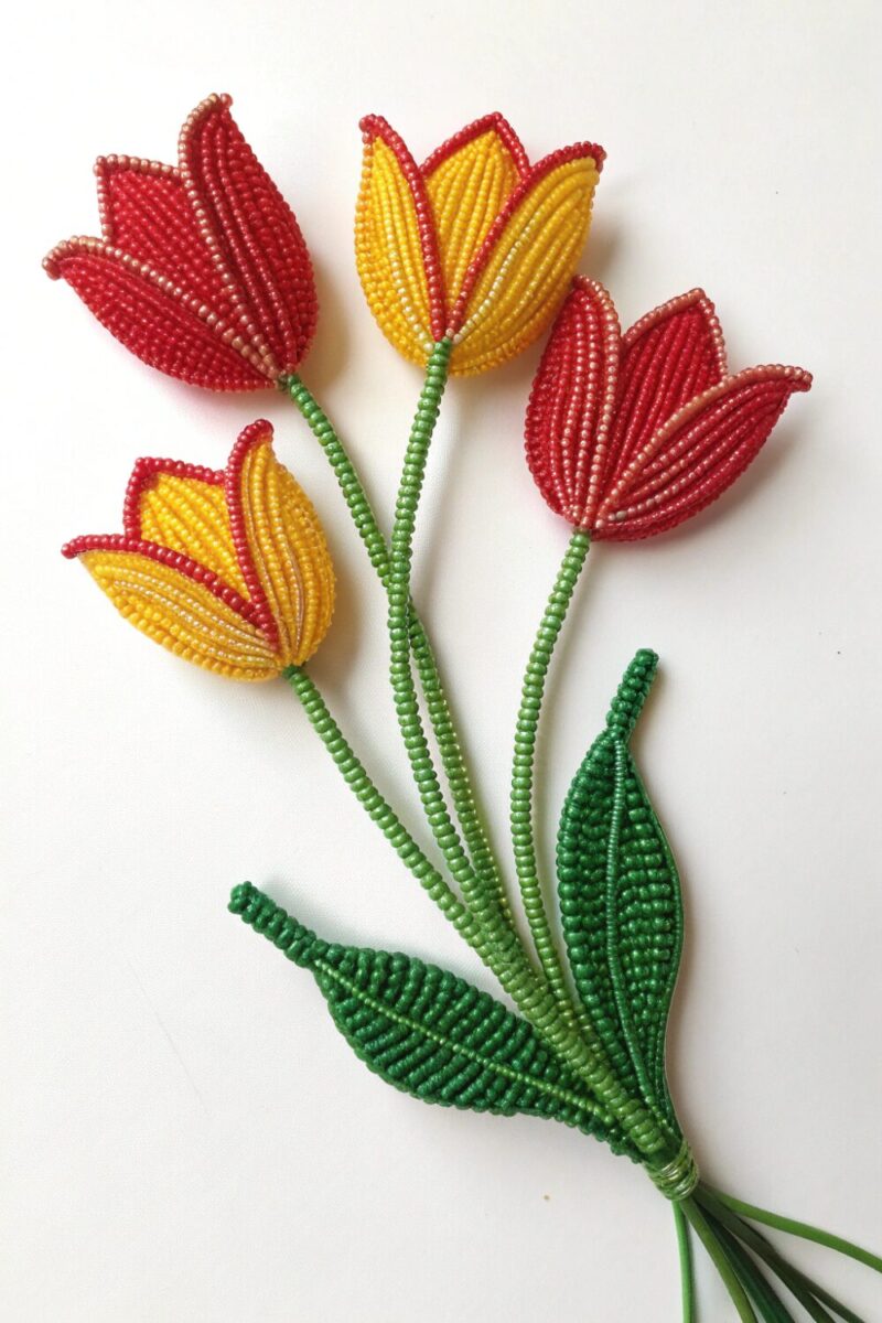 bright beaded tulip flower with five cup shaped pe